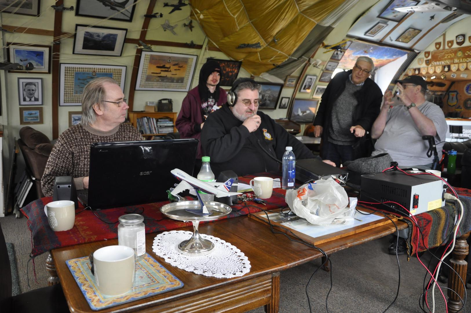 Greg 2W1BUF operating GB0WZL with Andy G7KNA logging. To the rear (left to right) is Ken M7MYU, David G7BYN and Matt G7FBD