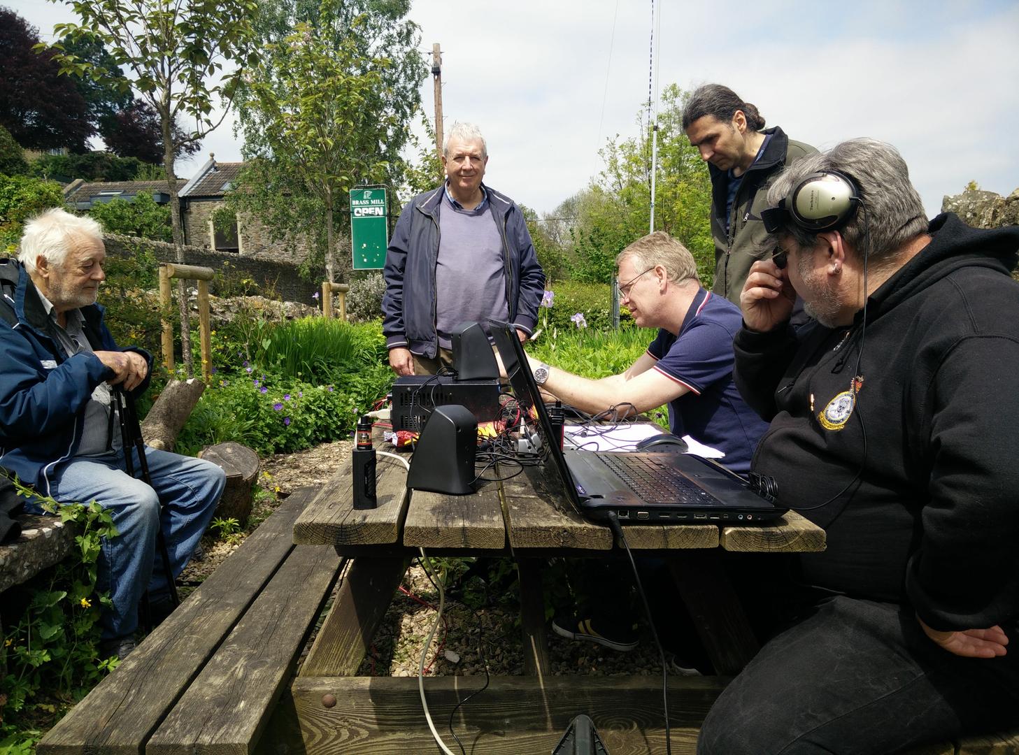Mark M0SKV operating GB0SBM with Greg 2W1BUF logging observers (left to right): Ken G4XCB (seated), Peter G0DRX and Dan 2E0IGS